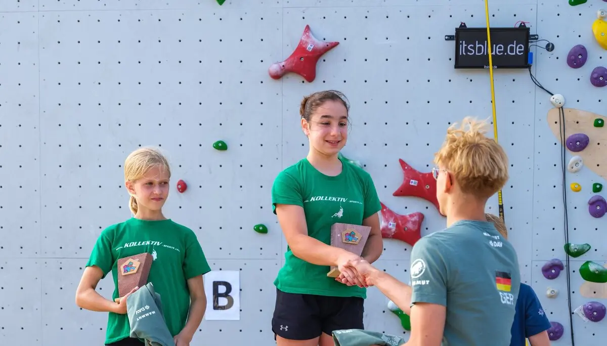 Zwei Mädchen auf einem Podest. Der auf dem ersten Platz wird gratuliert und ein Preis übergeben. | © @oliverclimb / Oliver Gobin