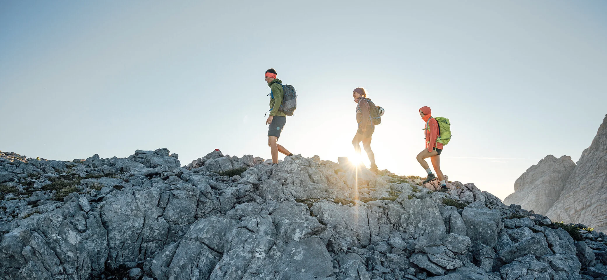 Drei Persinen besteigen im Sonnenaufgang einen Gipfel | © DAV / Julian Rohn